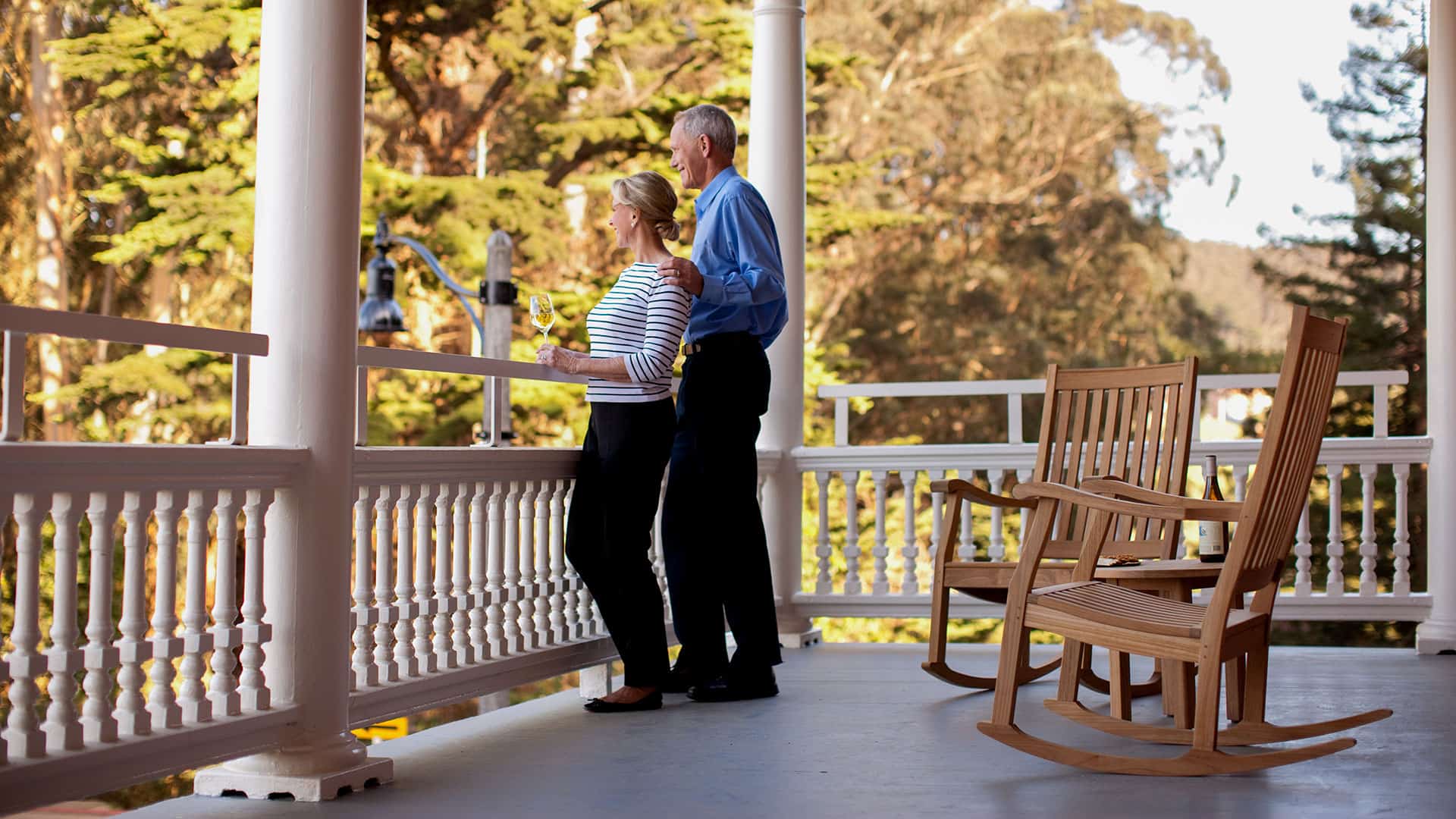 A Couple Enjoys Wine On The Front Porch at Inn at the Presidio