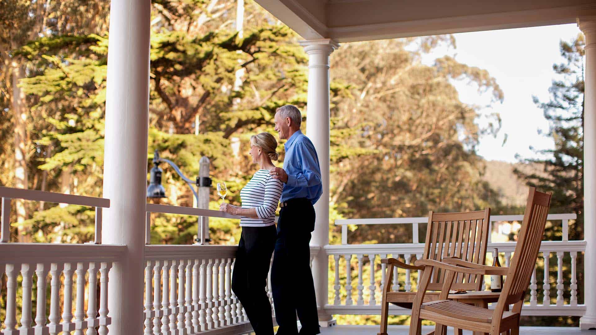 Couple Enjoys Wine On The Porch At Inn at the Presidio