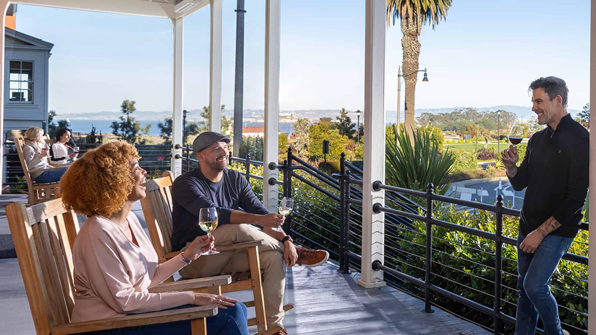 Lodge at the Presidio Front Porch With Rocking Chairs and Guests